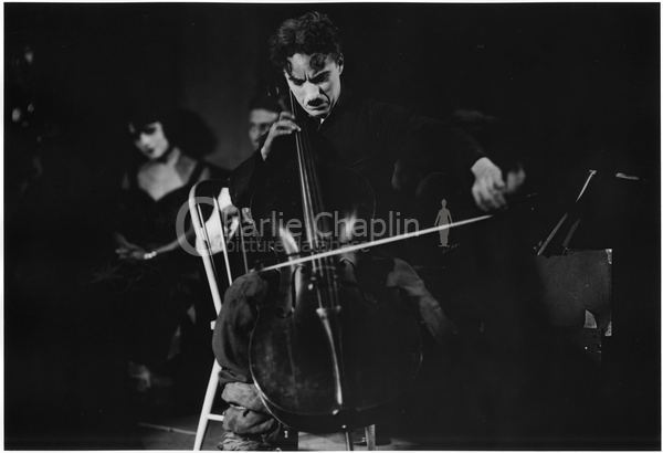 Chaplin playing the cello on the set of The Gold Rush