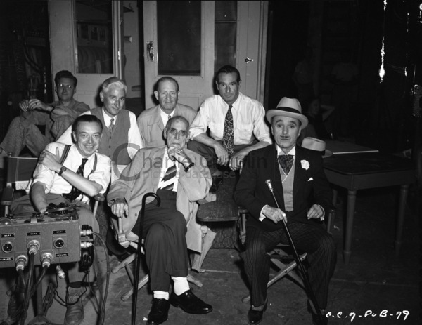 Robert Florey (front left), Wheeler Dryden (back, left of center), Henry Bergman (front center), Rollie Totheroh (back right), and Chaplin (front right) with crew members on the set of Monsieur Verdoux