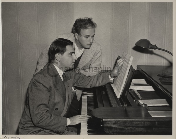 Charles Chaplin working with Meredith Willson on the music for The Great Dictator