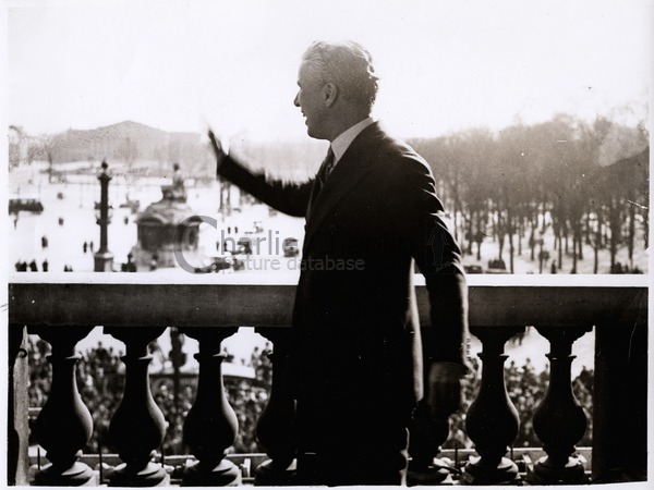 Chaplin waves from the balcony of the Crillon Hotel in Paris, 1931