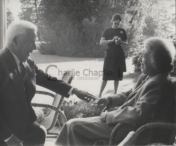 Charles Chaplin, Oona Chaplin (background) and pianist Clara Haskil at the Chaplin family home in Switzerland, the Manoir de Ban