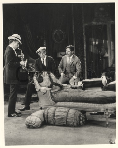 Chaplin with saxophone on the set of A Woman of Paris