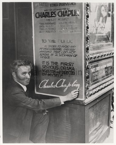 Chaplin signs a poster for A Woman of Paris
